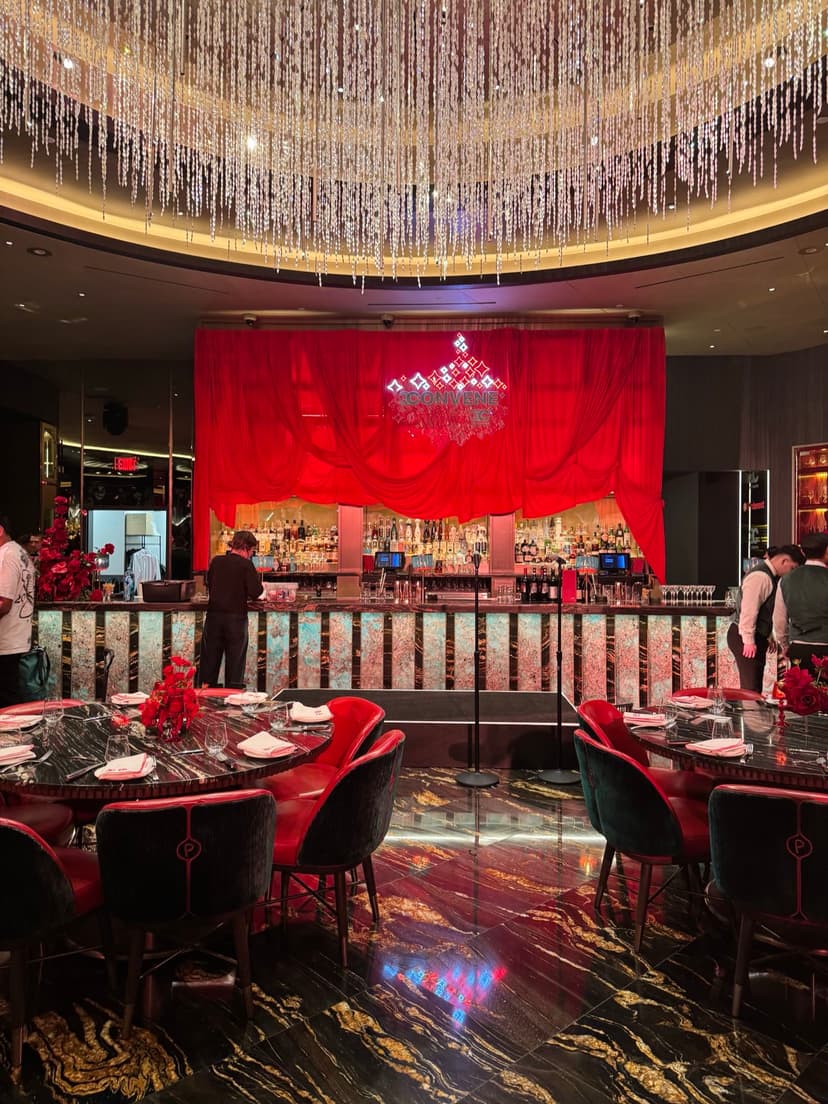 Red-themed event production with stage, draping, and lighting