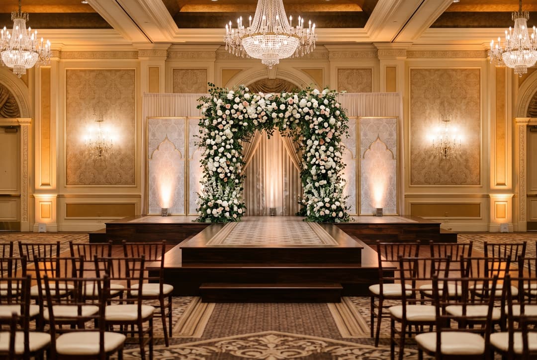 Custom-built wedding ceremony stage with floral arch at a Las Vegas luxury resort ballroom